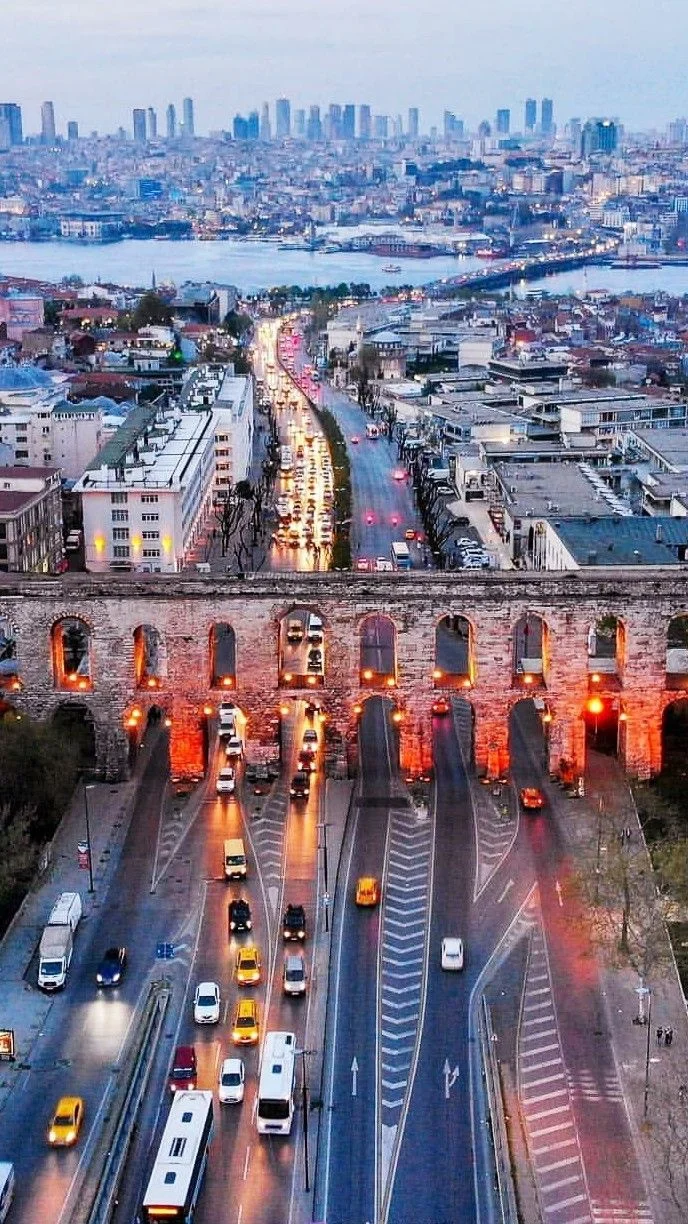 Evening view over Istanbul traffic and the Bosphorus beside the historic Valens Aqueduct